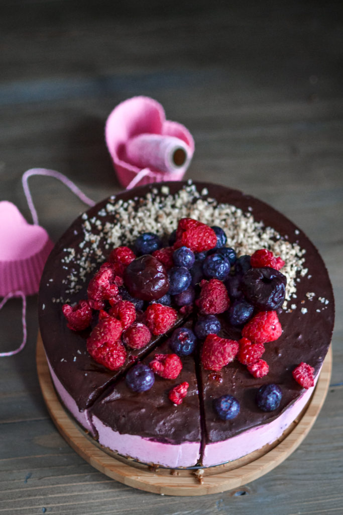 vegan raspberry cream cake with chocolate ganache and berries
