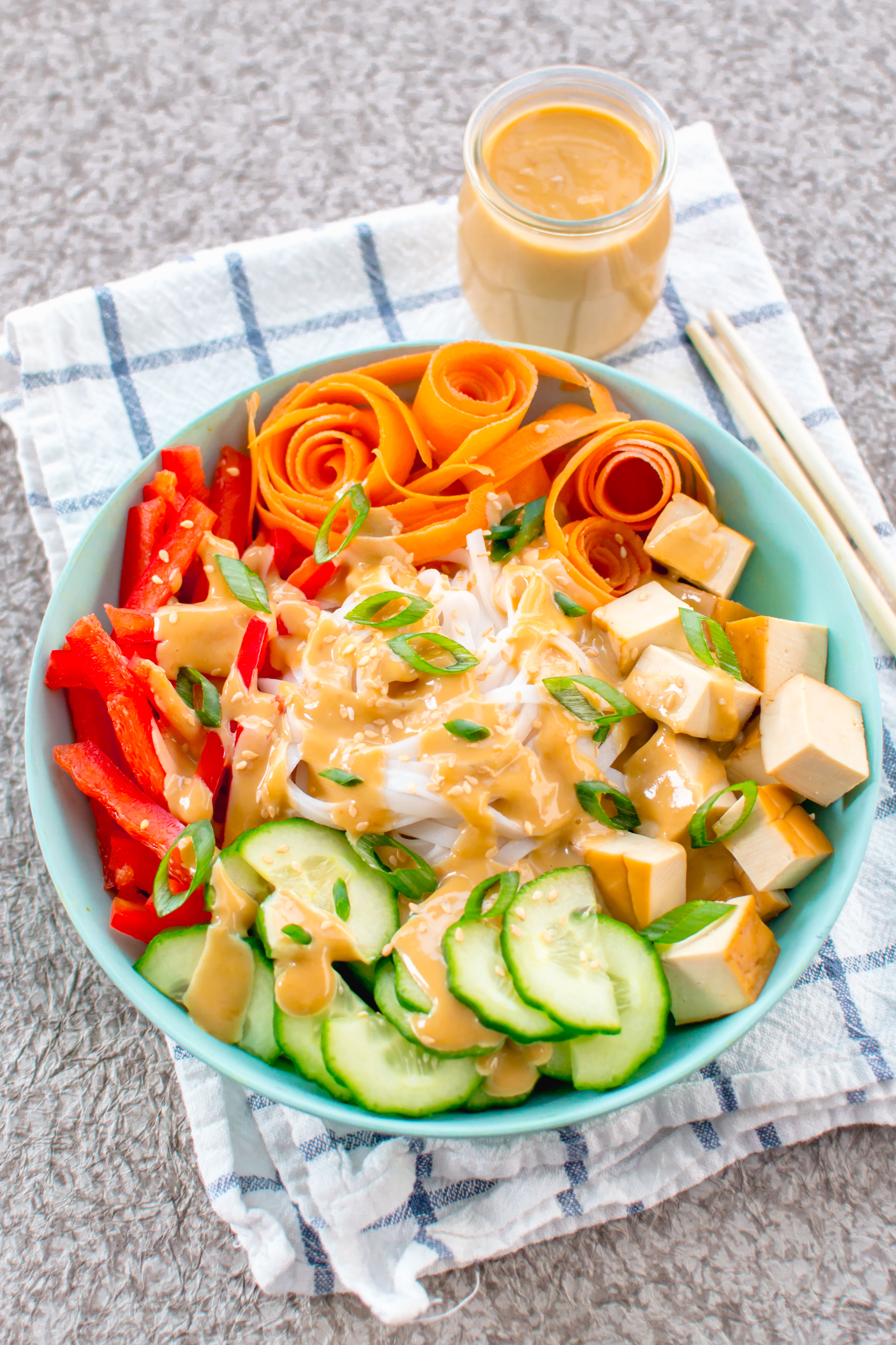 summer rice noodle bowl with assorted vegetables miso ginger tahini dressing