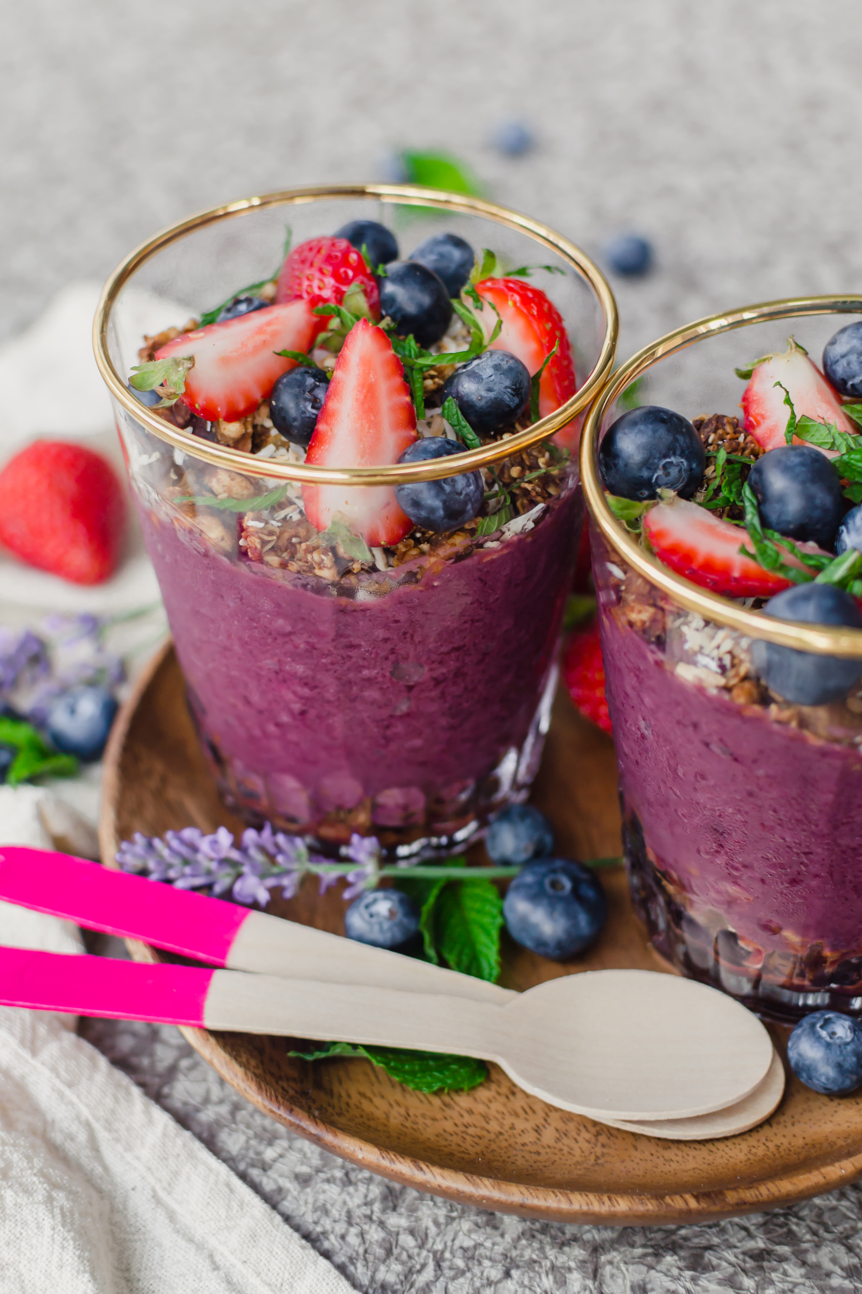acai parfaits in a cup with mint and berries