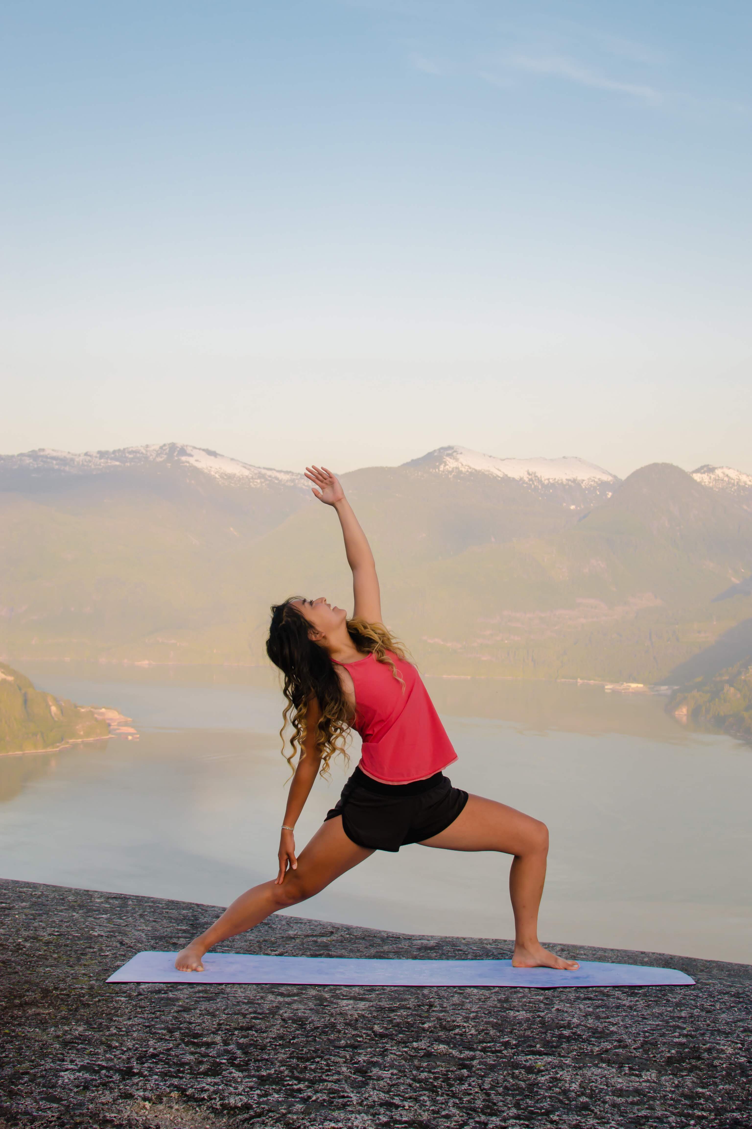 exalted warrior yoga pose with mountains